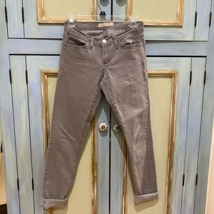 Grey skinny jeans (cuffed but may be uncuffed)